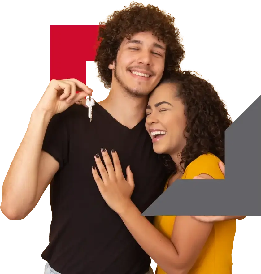 young couple holding keys to new home