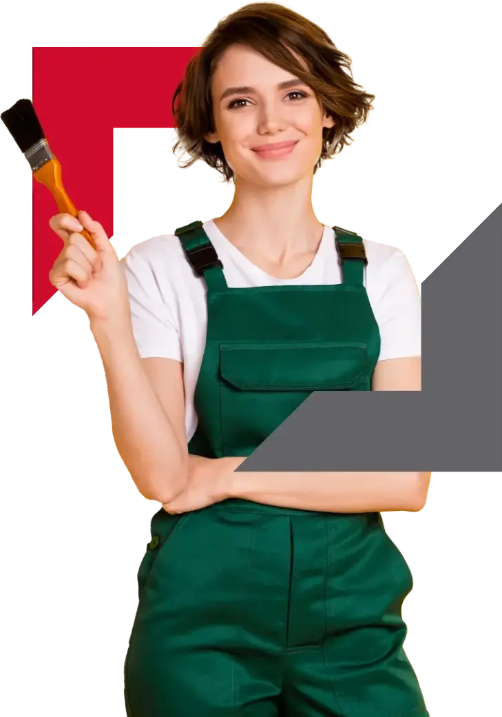 young woman in green overalls holding paint brush