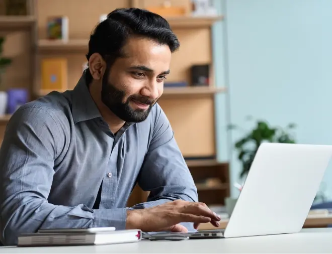 man smiling at computer