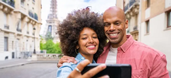 young couple taking selfie in Paris