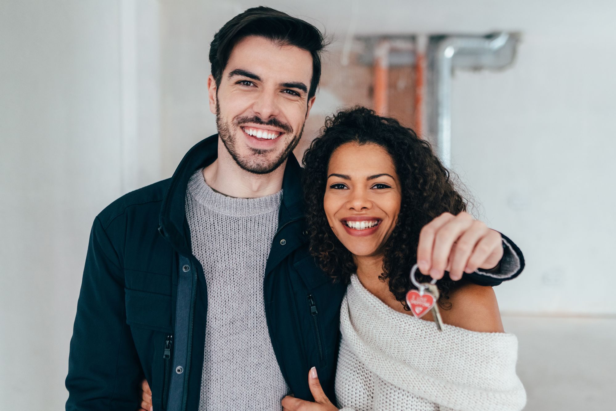 couple holding keys to a house