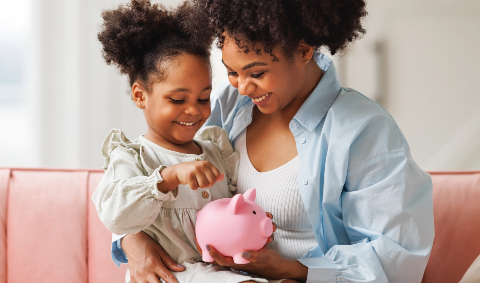 mother and daughter with piggy bank